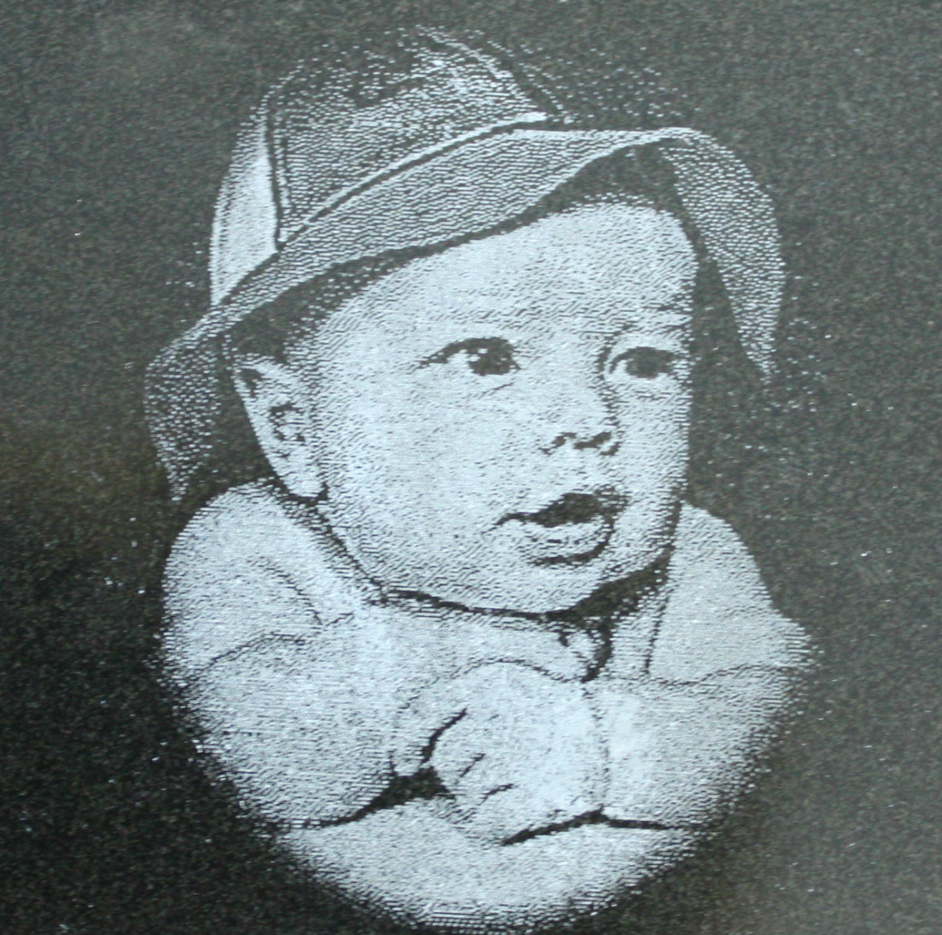 A darling picture of a baby lazer etched into a granite heart.