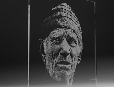 An old man of the sea, etched into black cardboard.